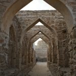 Stone arches inside a historic fort in Bahrain