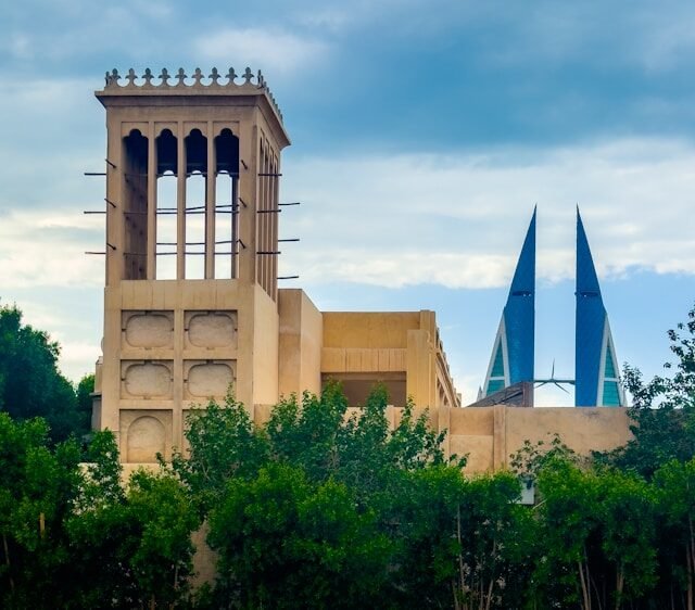 Traditional wind tower with the Bahrain World Trade Center behind
